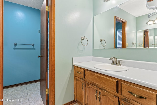 7300 Frank Snell Rd, Moss Point, MS 39562 - bathroom with vanity, tile patterned floors, a textured ceiling, and baseboards