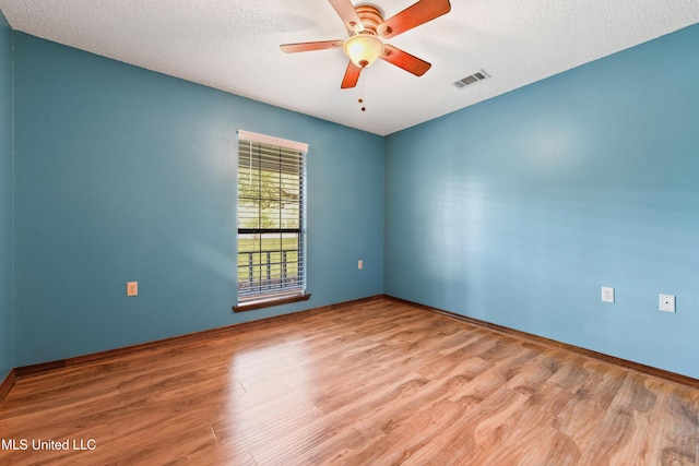 7300 Frank Snell Rd, Moss Point, MS 39562 - empty room featuring wood finished floors, ceiling fan, and a textured ceiling