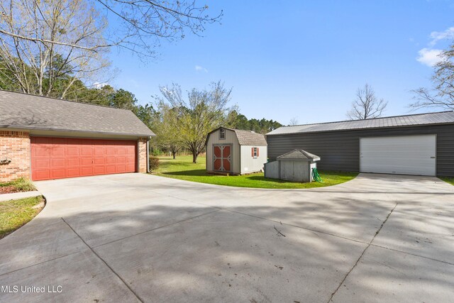 7300 Frank Snell Rd, Moss Point, MS 39562 - detached garage with a storage shed and driveway