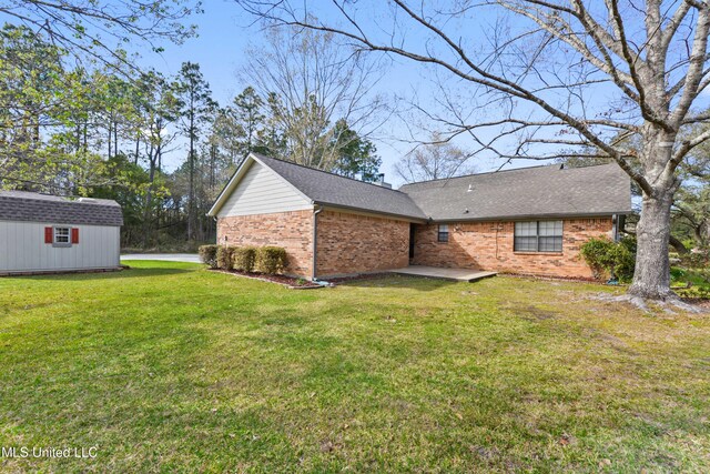 7300 Frank Snell Rd, Moss Point, MS 39562 - back of house with brick siding, a lawn, and a shingled roof