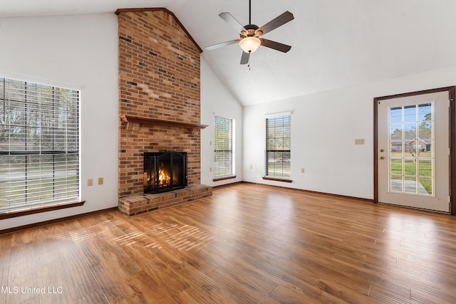 7300 Frank Snell Rd, Moss Point, MS 39562 - unfurnished living room with high vaulted ceiling, ceiling fan, wood finished floors, a fireplace, and baseboards