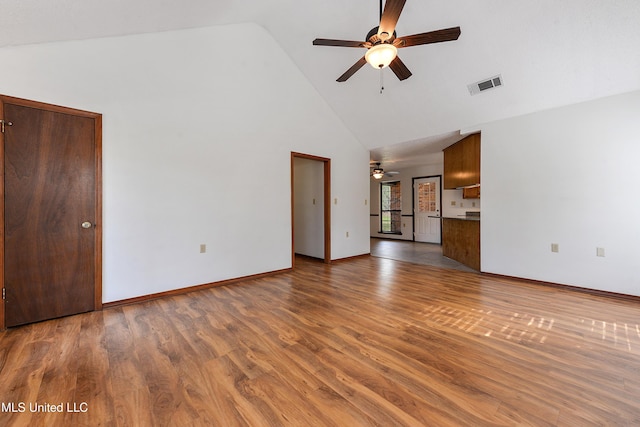 7300 Frank Snell Rd, Moss Point, MS 39562 - unfurnished living room with a ceiling fan, high vaulted ceiling, wood finished floors, and baseboards