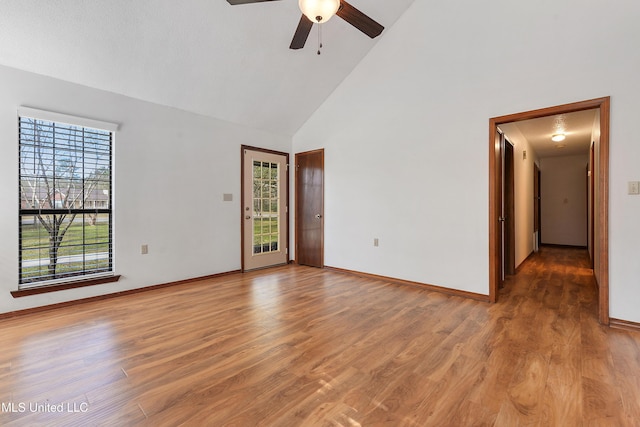 7300 Frank Snell Rd, Moss Point, MS 39562 - spare room featuring high vaulted ceiling, a ceiling fan, wood finished floors, and baseboards
