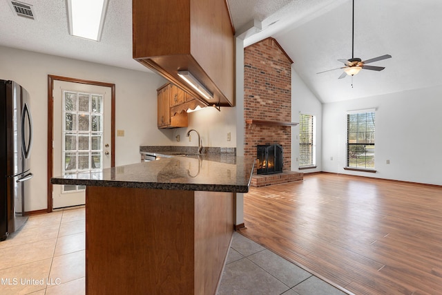 7300 Frank Snell Rd, Moss Point, MS 39562 - kitchen with freestanding refrigerator, light tile patterned floors, a sink, a ceiling fan, and a textured ceiling