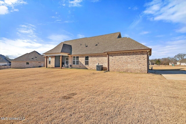 rear view of house featuring central AC unit