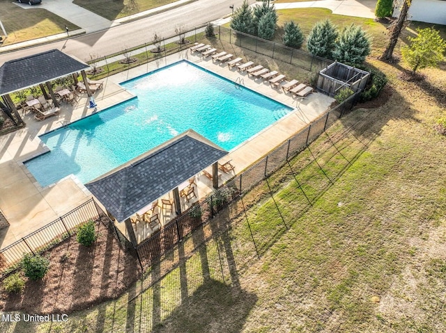 view of pool featuring a patio area and a yard