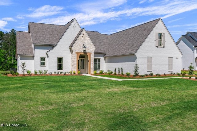 french provincial home with a front lawn