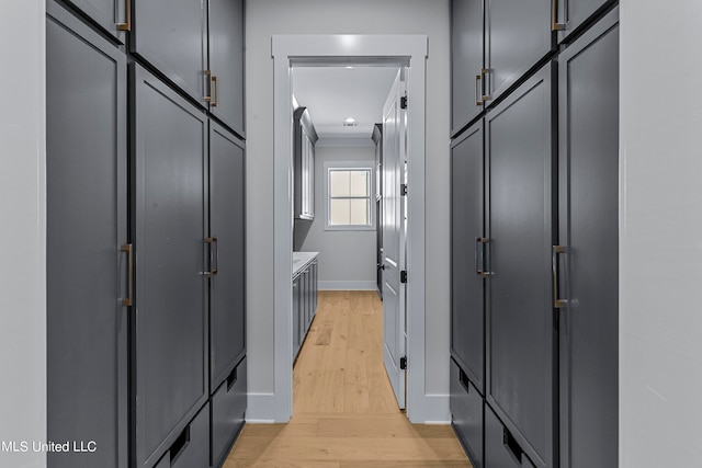 hallway featuring crown molding and light wood-type flooring