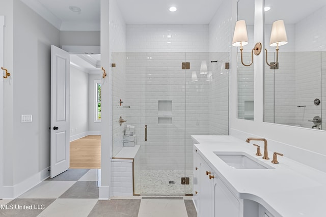 bathroom with vanity, hardwood / wood-style flooring, and a shower with door