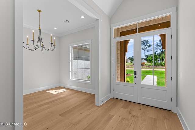 entrance foyer featuring french doors, plenty of natural light, and light wood-type flooring