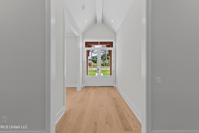 corridor featuring lofted ceiling with beams and light hardwood / wood-style flooring