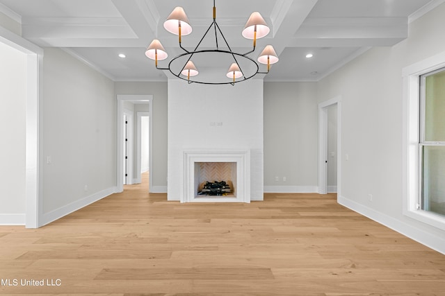 unfurnished living room featuring a large fireplace, light hardwood / wood-style flooring, ornamental molding, beamed ceiling, and a notable chandelier