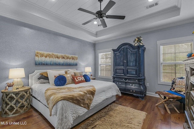 bedroom featuring a raised ceiling, ornamental molding, ceiling fan, and dark hardwood / wood-style flooring