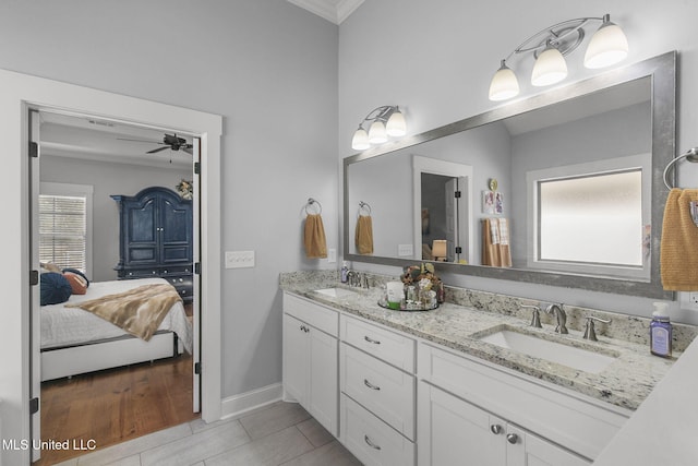 bathroom with crown molding, ceiling fan, vanity, and tile patterned flooring