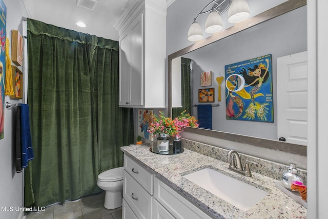 bathroom featuring tile patterned flooring, vanity, and toilet