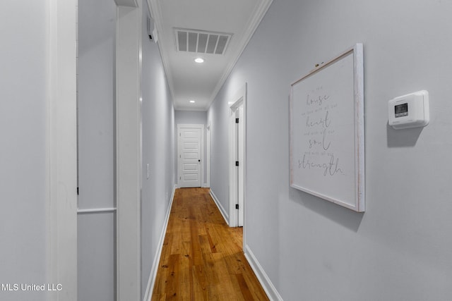 corridor featuring crown molding and hardwood / wood-style floors