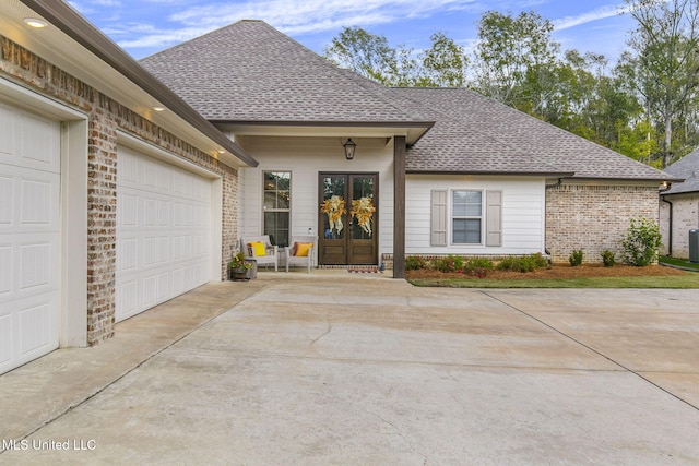 view of front of property with a garage and french doors