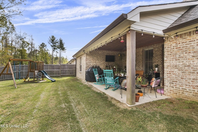 view of yard with a playground and a patio area