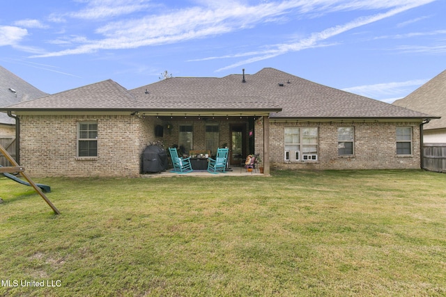 rear view of property featuring a patio and a lawn