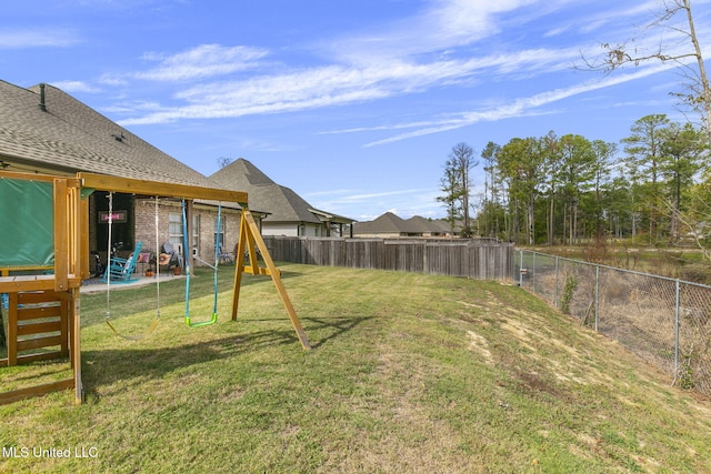 view of yard featuring a playground and a patio area