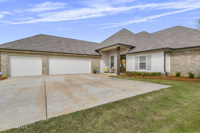 view of front of property with a garage and a front yard