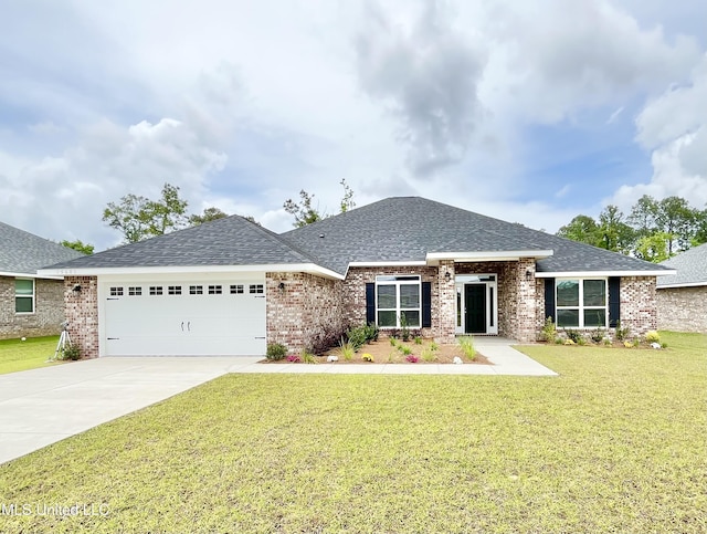 15681 Perdido Dr, Gulfport, MS 39503 - view of front of house featuring a garage, roof with shingles, a front yard, and concrete driveway