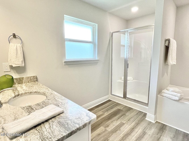 15681 Perdido Dr, Gulfport, MS 39503 - full bath with a stall shower, wood finished floors, baseboards, and vanity