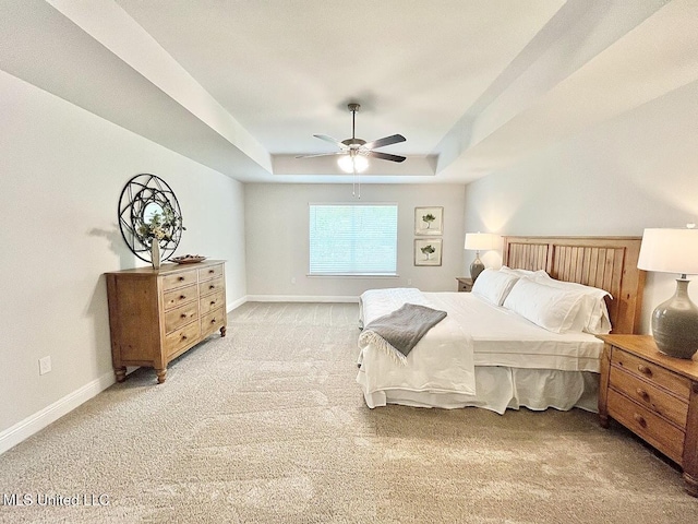 15681 Perdido Dr, Gulfport, MS 39503 - bedroom with a raised ceiling, light carpet, baseboards, and a ceiling fan