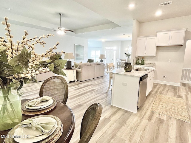 15681 Perdido Dr, Gulfport, MS 39503 - kitchen with stainless steel dishwasher, light wood-style floors, a sink, and ceiling fan