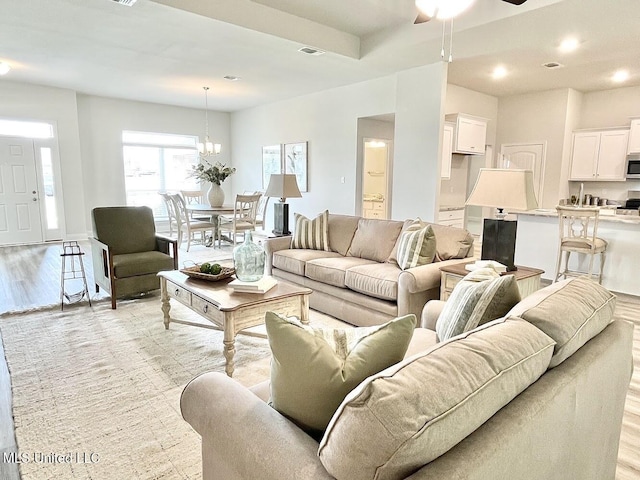 15681 Perdido Dr, Gulfport, MS 39503 - living room featuring light wood-type flooring, a ceiling fan, a chandelier, and recessed lighting
