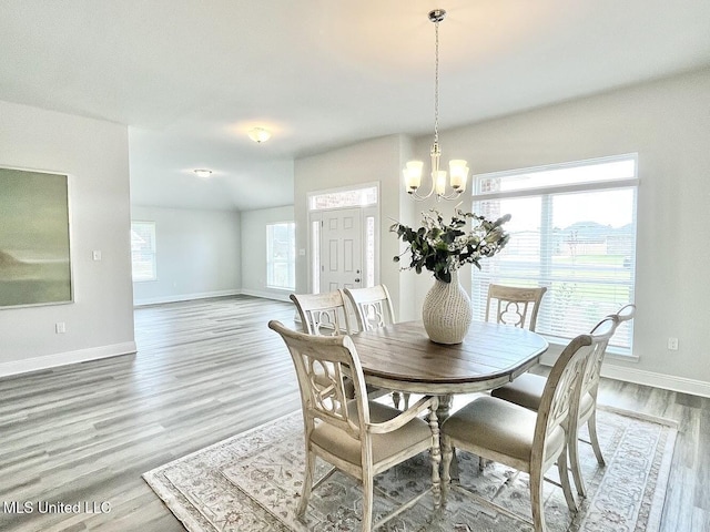 15681 Perdido Dr, Gulfport, MS 39503 - dining room featuring a chandelier, baseboards, and wood finished floors