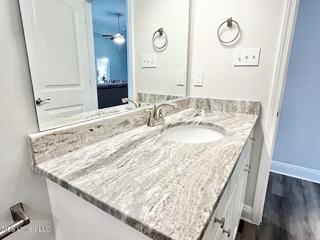 15681 Perdido Dr, Gulfport, MS 39503 - bathroom featuring vanity, ceiling fan, baseboards, and wood finished floors