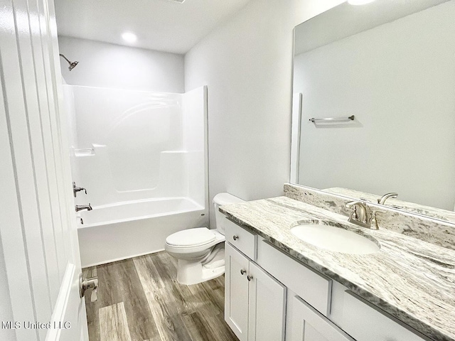 15681 Perdido Dr, Gulfport, MS 39503 - full bathroom featuring wood finished floors, vanity, toilet, and bathtub / shower combination