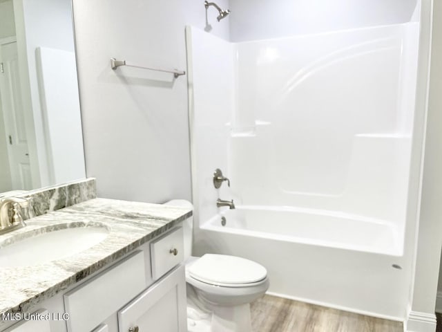 15681 Perdido Dr, Gulfport, MS 39503 - bathroom with vanity, toilet, wood finished floors, and shower / washtub combination