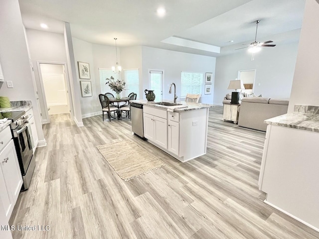 15681 Perdido Dr, Gulfport, MS 39503 - kitchen featuring appliances with stainless steel finishes, white cabinets, a sink, ceiling fan, and light wood-style flooring