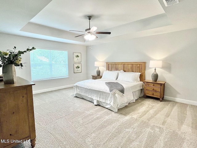 15681 Perdido Dr, Gulfport, MS 39503 - carpeted bedroom featuring a tray ceiling, baseboards, and ceiling fan