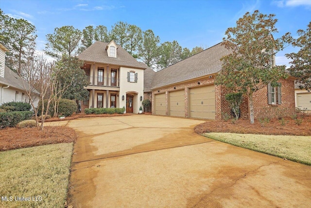 view of front of property featuring a garage and a balcony