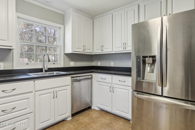 5360 Wayneland Dr, Jackson, MS 39211 - kitchen featuring dark countertops, appliances with stainless steel finishes, white cabinetry, and a sink