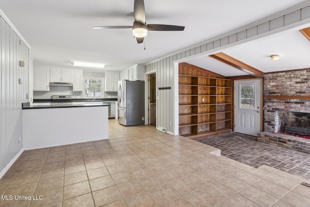 5360 Wayneland Dr, Jackson, MS 39211 - kitchen featuring built in shelves, ceiling fan, stainless steel appliances, white cabinetry, and dark countertops