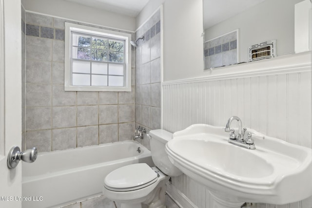 5360 Wayneland Dr, Jackson, MS 39211 - bathroom with wainscoting, toilet, bathtub / shower combination, and a sink