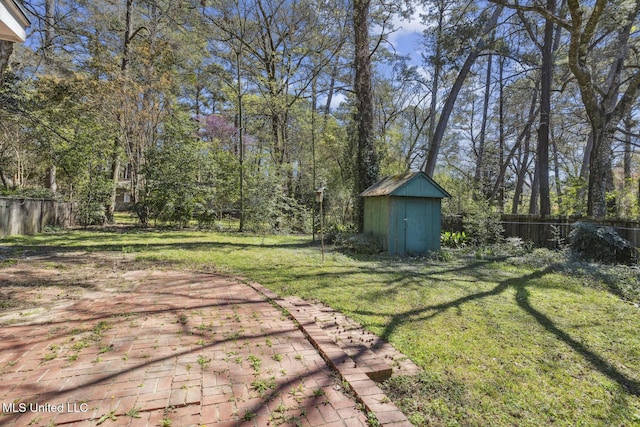 5360 Wayneland Dr, Jackson, MS 39211 - view of yard featuring an outdoor structure, a storage unit, and a fenced backyard
