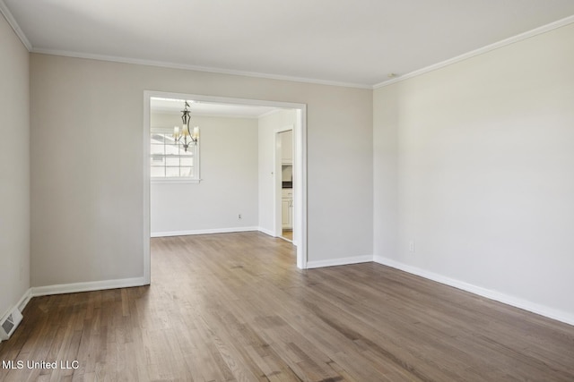 5360 Wayneland Dr, Jackson, MS 39211 - unfurnished room featuring a notable chandelier, ornamental molding, baseboards, and wood finished floors