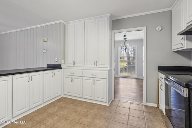 5360 Wayneland Dr, Jackson, MS 39211 - kitchen with dark countertops, electric range oven, white cabinets, crown molding, and a notable chandelier