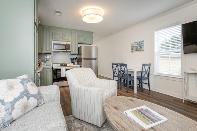 living room featuring crown molding, baseboards, dark wood-type flooring, and visible vents