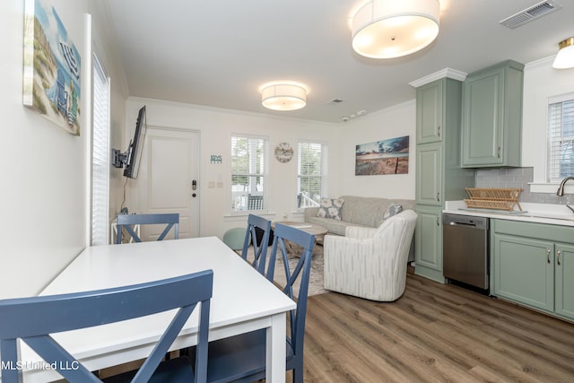 dining room featuring crown molding, visible vents, and wood finished floors