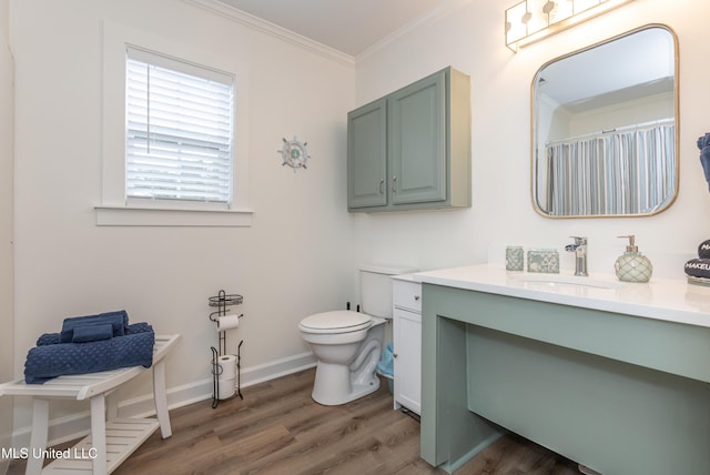 full bath featuring toilet, baseboards, ornamental molding, vanity, and wood finished floors