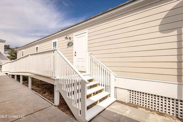 view of exterior entry featuring a deck