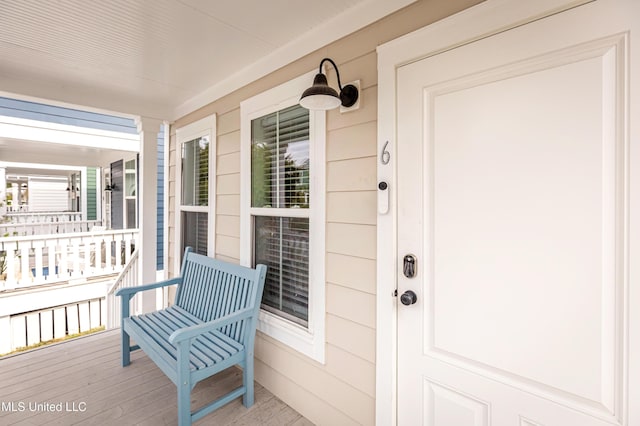 view of exterior entry with covered porch