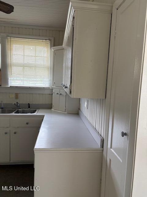 301 Hampton St, Indianola, MS 38751 - interior space with a sink, light countertops, and white cabinets