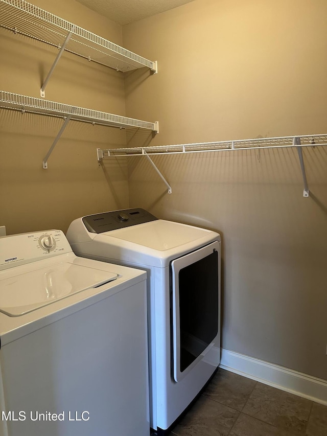 laundry area with washer and dryer, laundry area, and baseboards